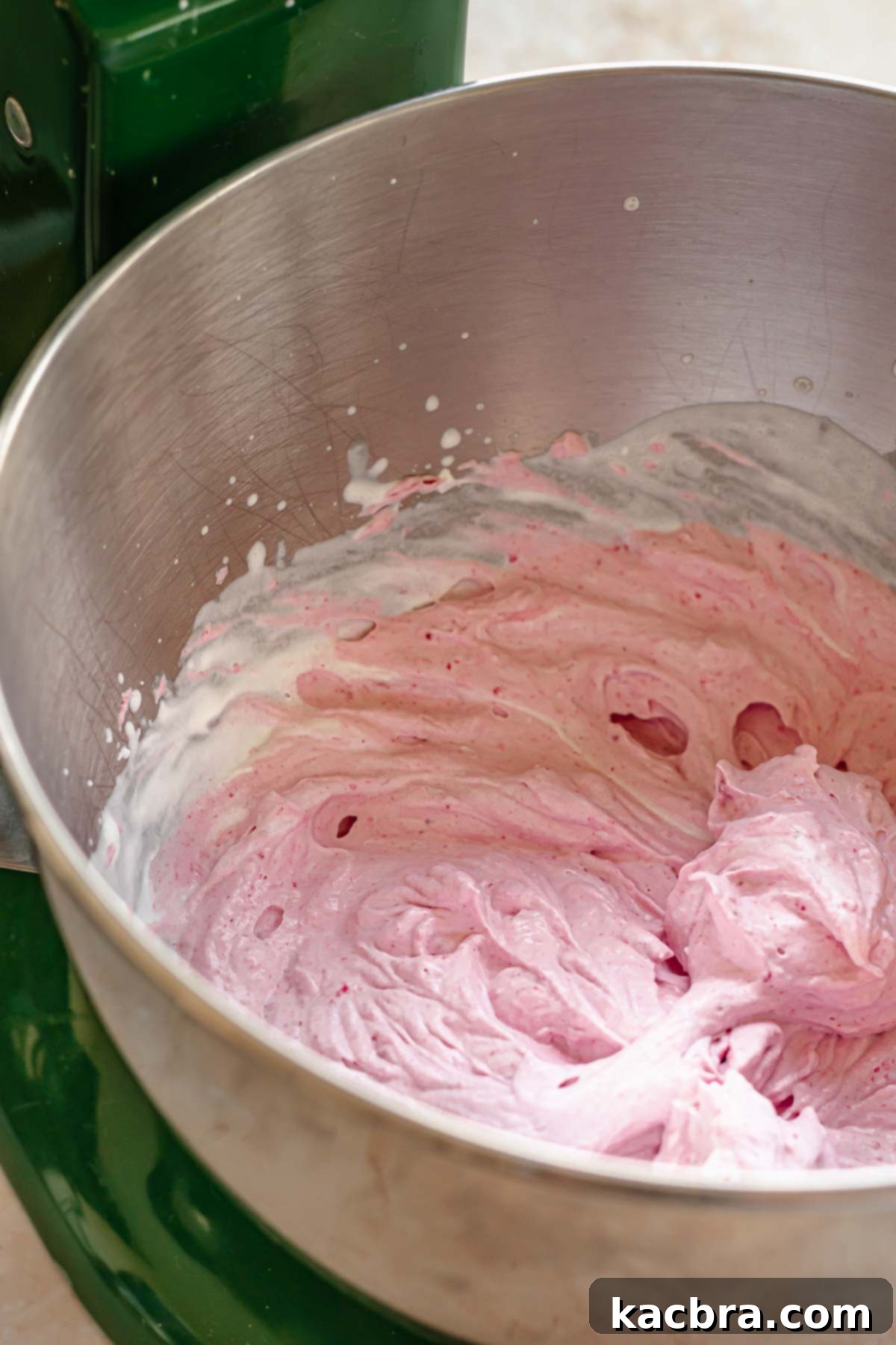 Raspberry whipped cream in a bowl, beautifully combined.