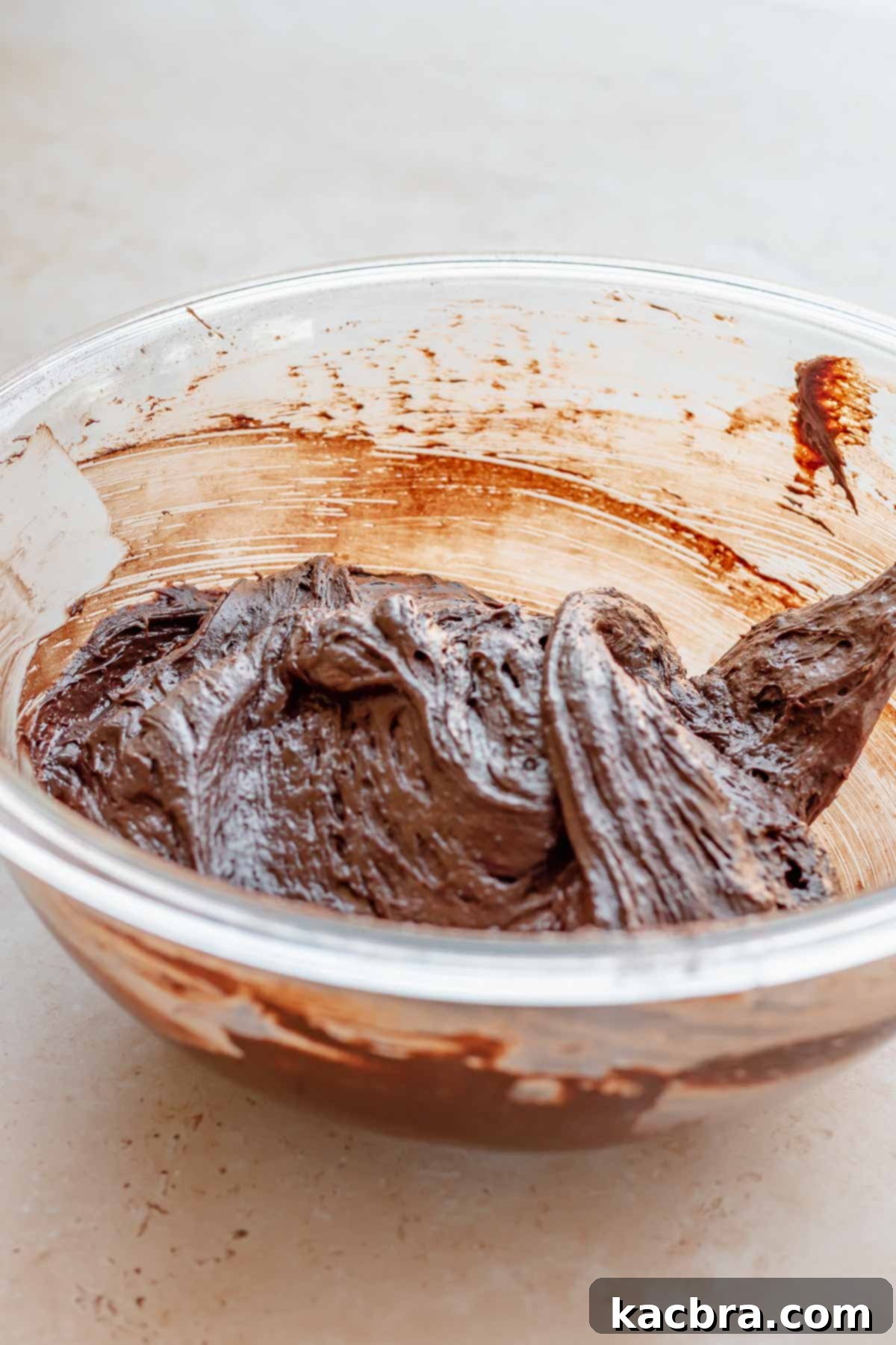 Thick chocolate cake batter in a bowl, showing its rich consistency.