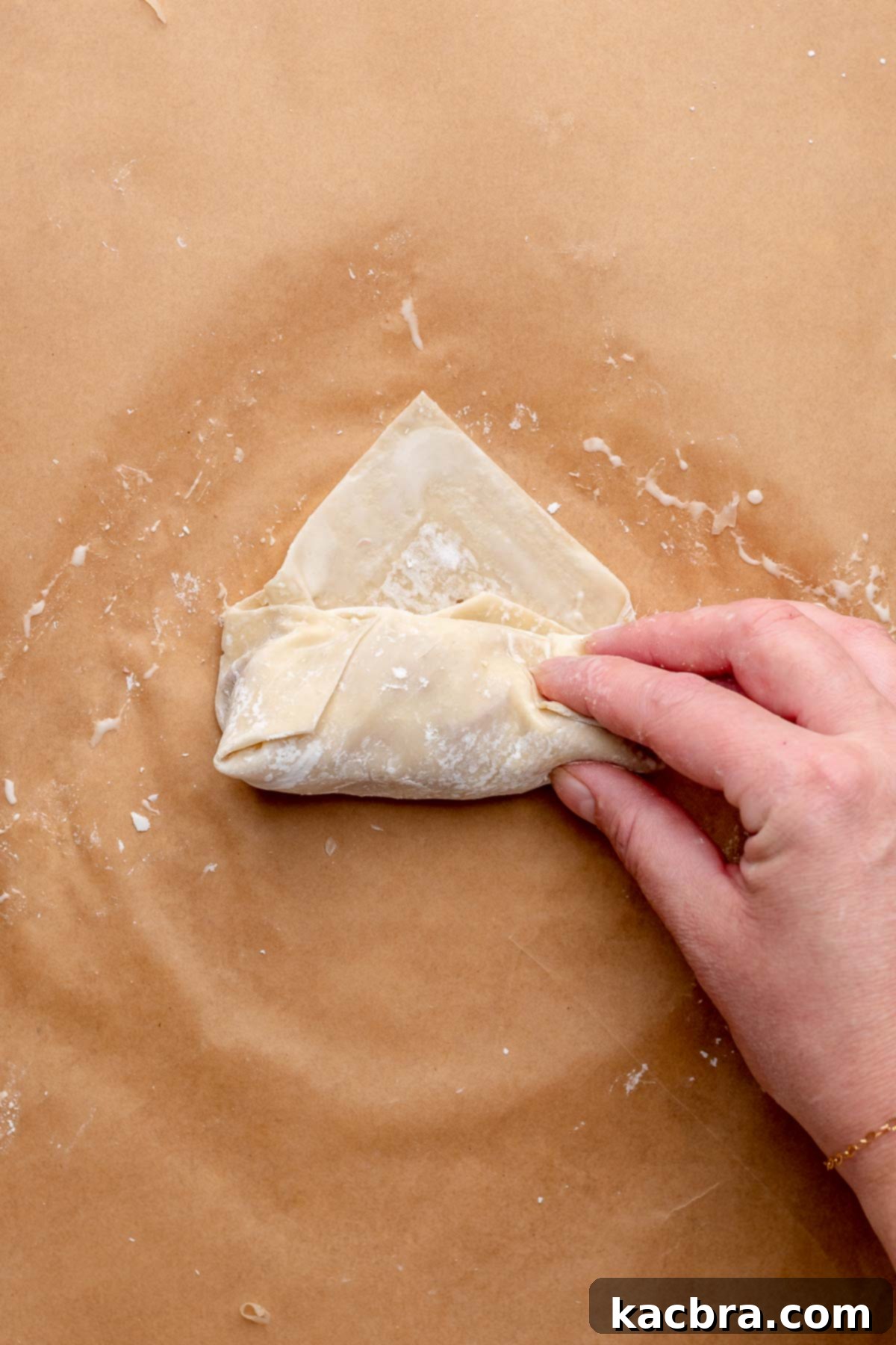 Reuben Spring Rolls 9 A hand folds an egg roll into shape